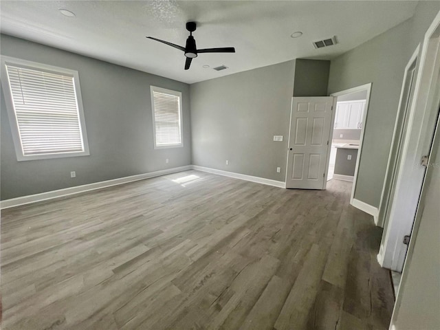 3413 N 72nd St, Tampa, FL 33619 - unfurnished bedroom with wood finished floors, baseboards, and a ceiling fan