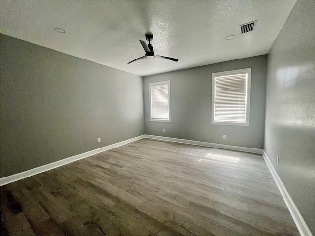 3413 N 72nd St, Tampa, FL 33619 - spare room with wood finished floors, ceiling fan, baseboards, and a textured ceiling