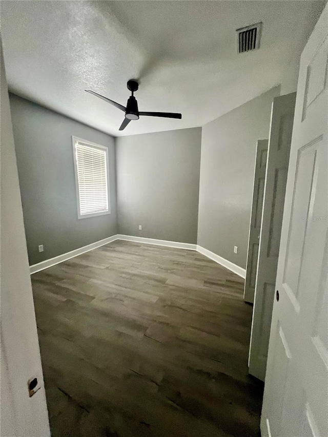 3413 N 72nd St, Tampa, FL 33619 - unfurnished room featuring wood finished floors, ceiling fan, a textured ceiling, and baseboards