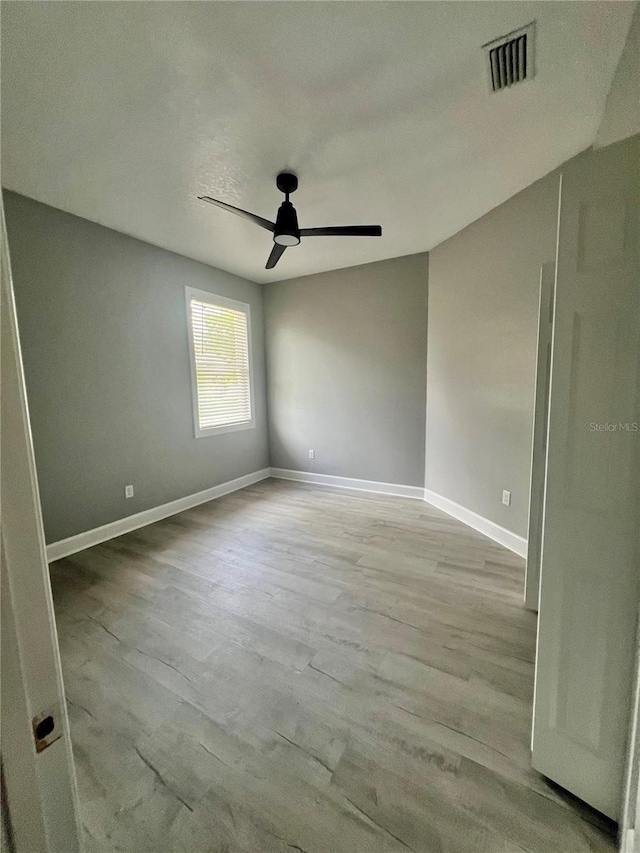 3413 N 72nd St, Tampa, FL 33619 - spare room with a ceiling fan, wood finished floors, and baseboards
