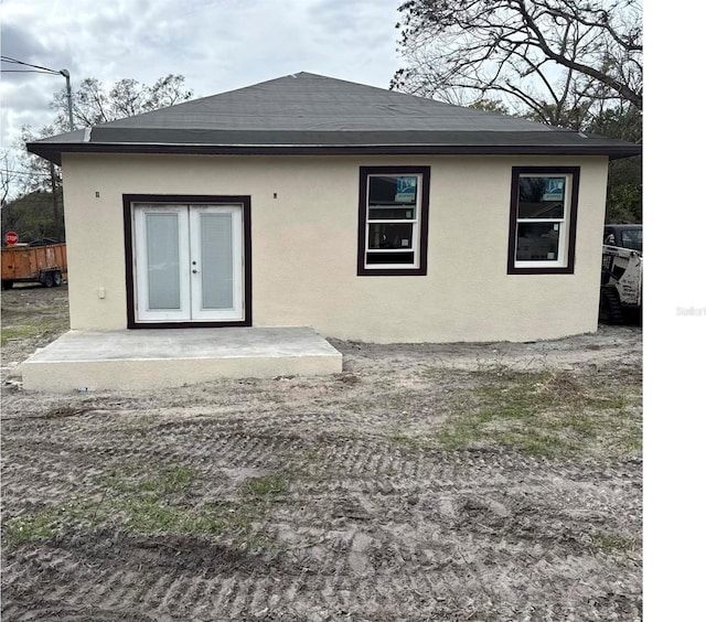 3413 N 72nd St, Tampa, FL 33619 - rear view of property featuring french doors, stucco siding, and a shingled roof