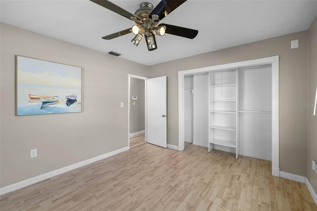 unfurnished bedroom featuring light wood-style floors, a closet, visible vents, and baseboards