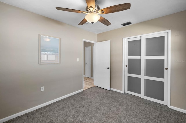 unfurnished bedroom with visible vents, baseboards, ceiling fan, carpet, and a closet