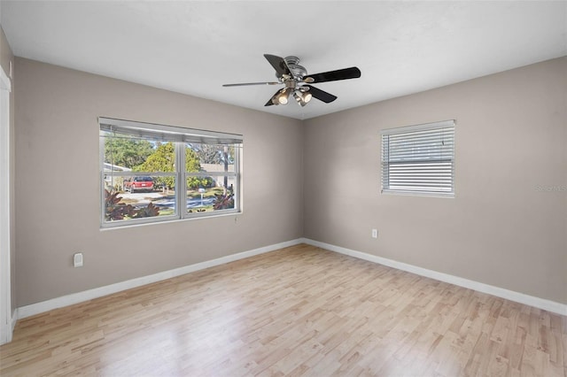 unfurnished room featuring light wood finished floors and baseboards