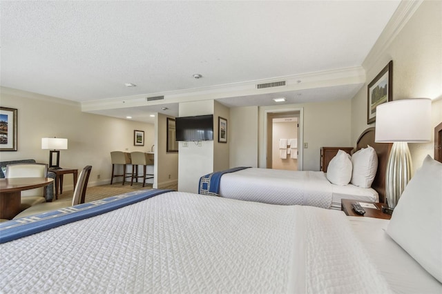 bedroom with ornamental molding and a textured ceiling