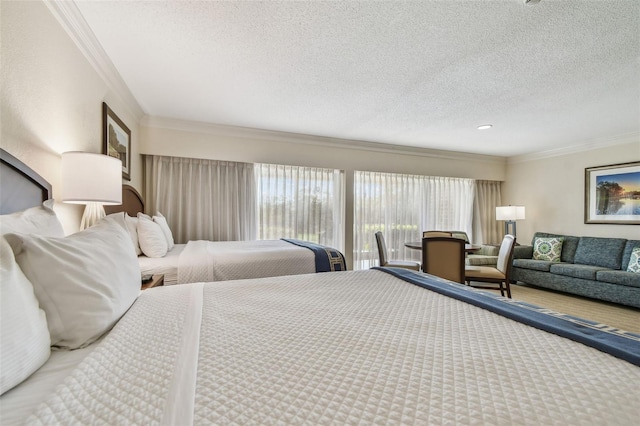 bedroom featuring multiple windows, crown molding, access to outside, and a textured ceiling