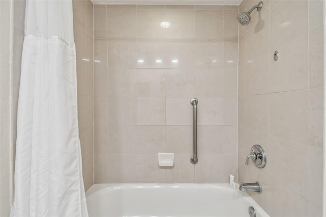 bathroom with shower / bath combo with shower curtain