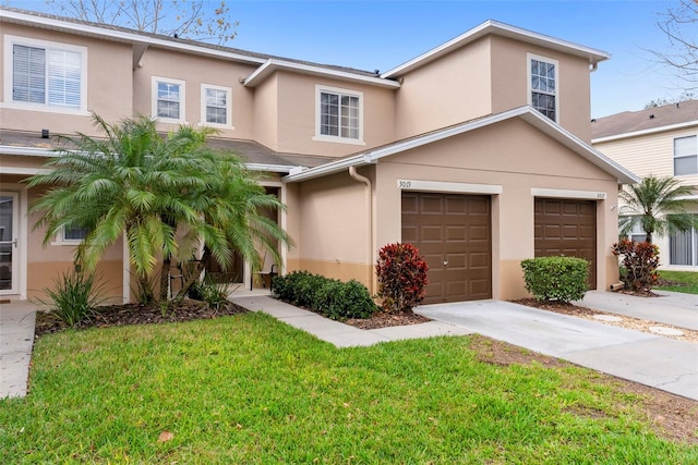 view of front of house featuring a garage and a front lawn