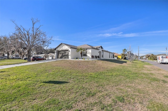 view of front facade featuring concrete driveway, a front lawn, an attached garage, and stucco siding