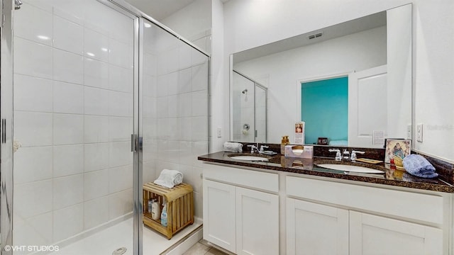 bathroom featuring walk in shower and vanity