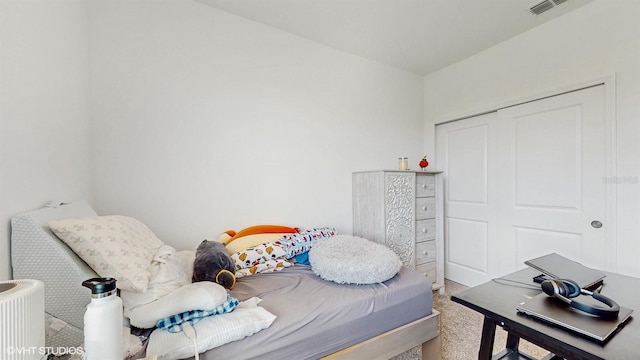 carpeted bedroom with a closet