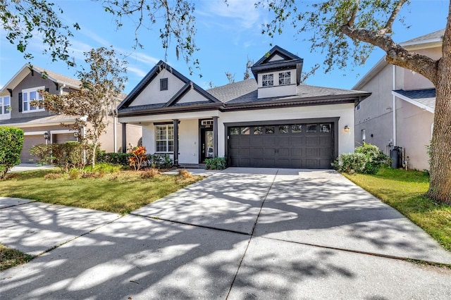 view of front of house with a garage, a front yard, and covered porch