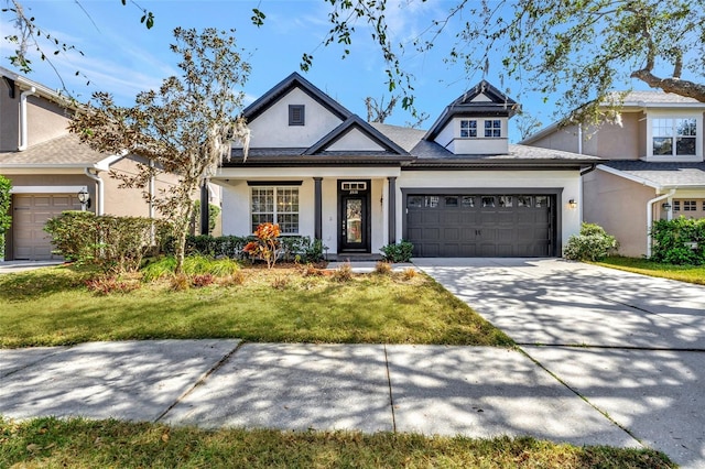 view of front of property featuring a garage and a front yard