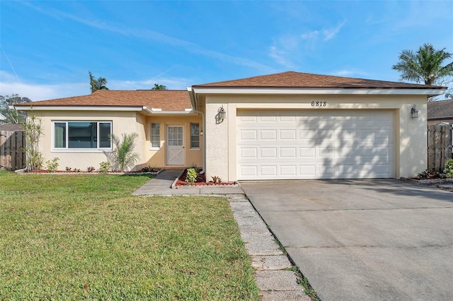 ranch-style home featuring a garage and a front lawn