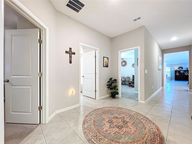 corridor featuring light tile patterned floors