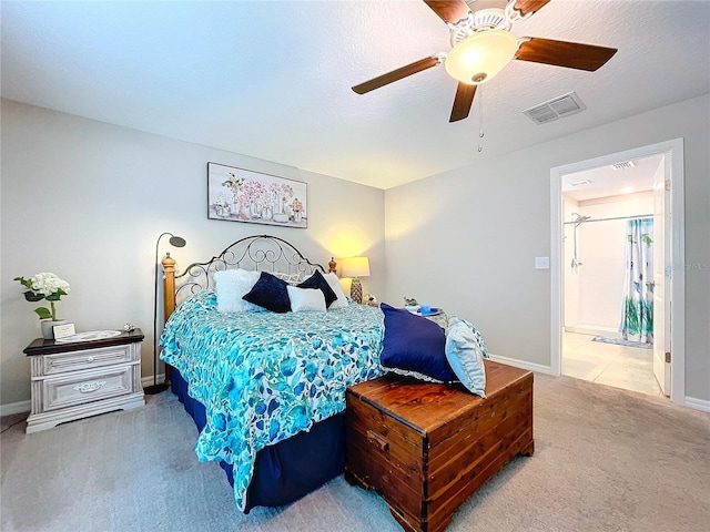 carpeted bedroom featuring ceiling fan and a textured ceiling