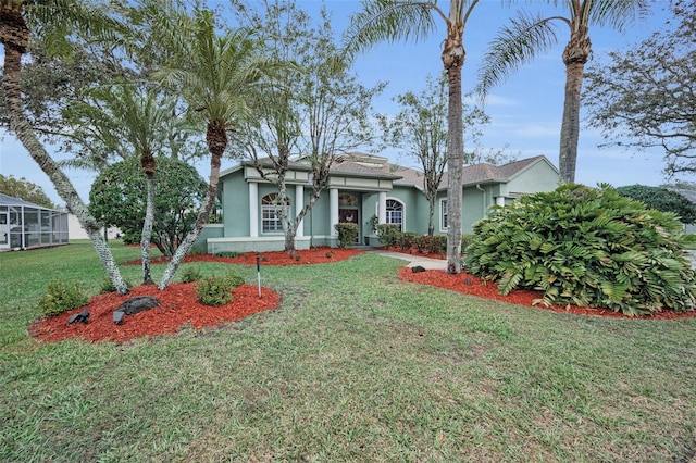 view of front of house featuring a front lawn and stucco siding