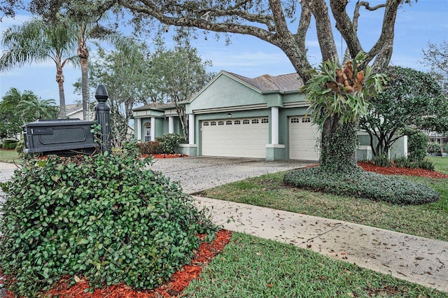 ranch-style home with a garage, driveway, and stucco siding