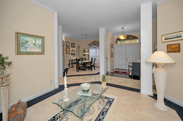 foyer entrance with ornamental molding, baseboards, and wood finished floors