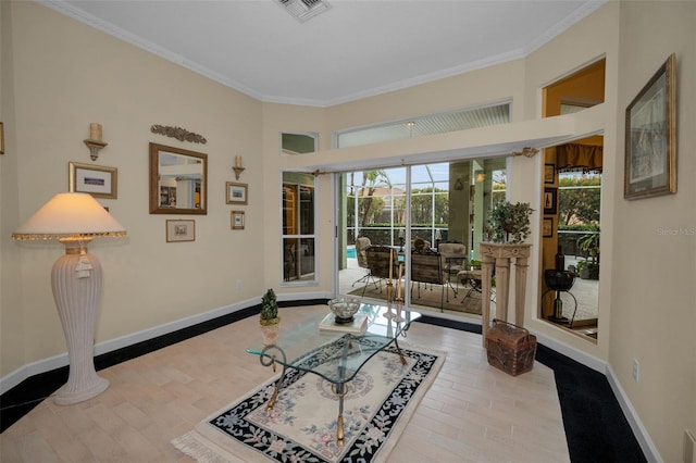 interior space featuring ornamental molding, a sunroom, visible vents, and baseboards