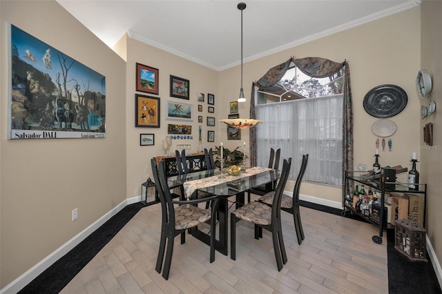 dining space featuring ornamental molding and baseboards