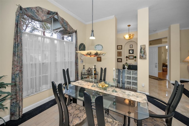 dining space featuring baseboards, arched walkways, and crown molding