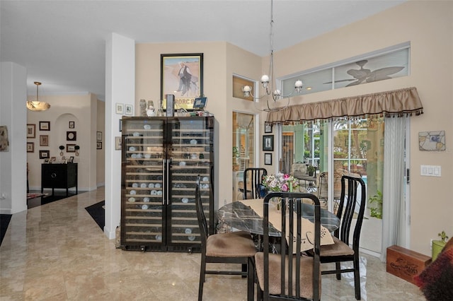 dining space featuring arched walkways and an inviting chandelier