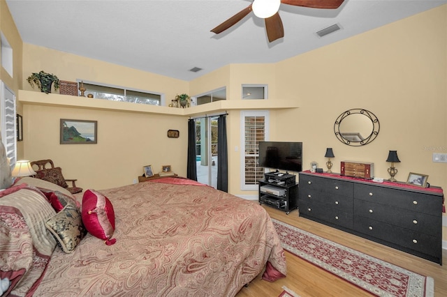 bedroom with ceiling fan, wood finished floors, and visible vents