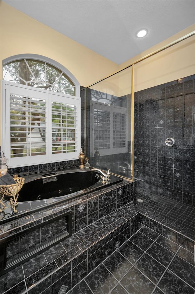 bathroom with tiled shower and a whirlpool tub