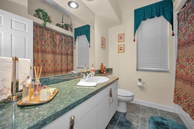 full bath featuring curtained shower, baseboards, vanity, and toilet