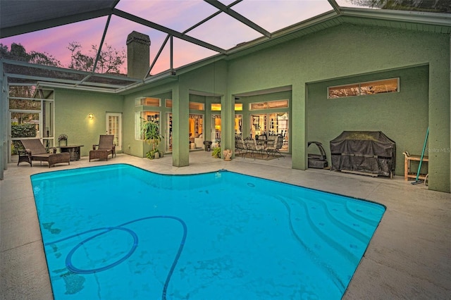 pool featuring an outdoor hangout area, a patio area, and a lanai