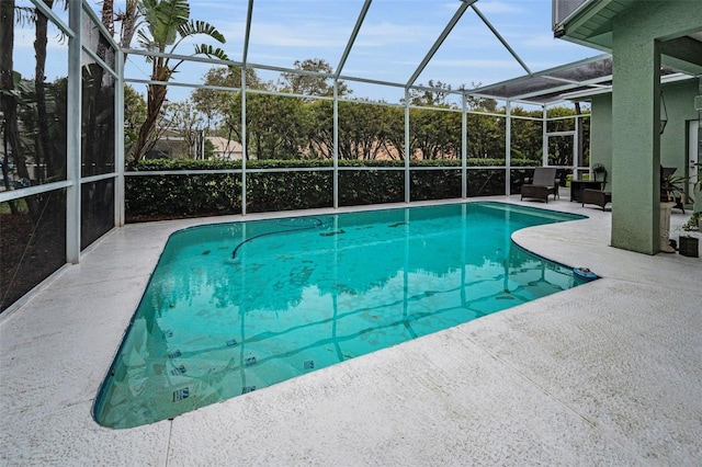 outdoor pool with a lanai and a patio