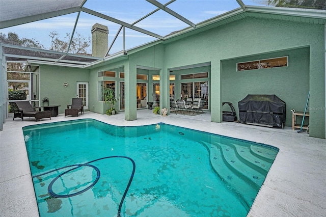 pool with a patio, area for grilling, and a lanai