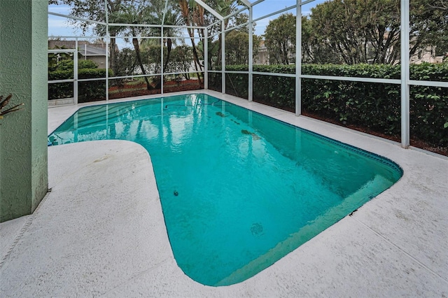 pool with a lanai and a patio area