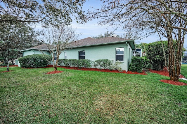 view of home's exterior featuring a yard and stucco siding