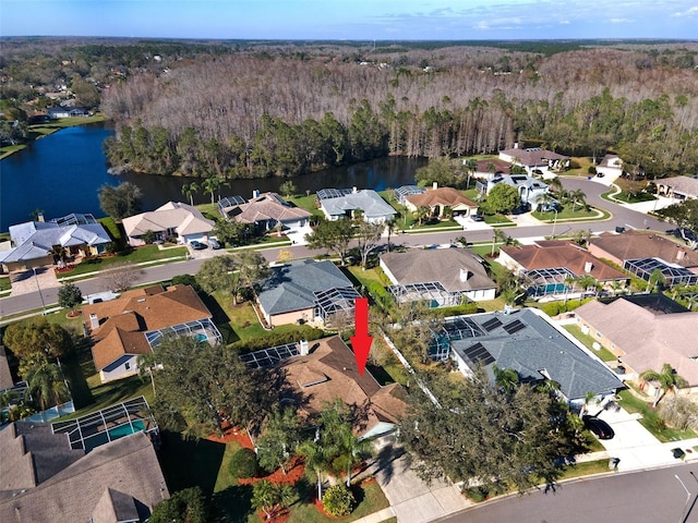 bird's eye view featuring a water view, a wooded view, and a residential view