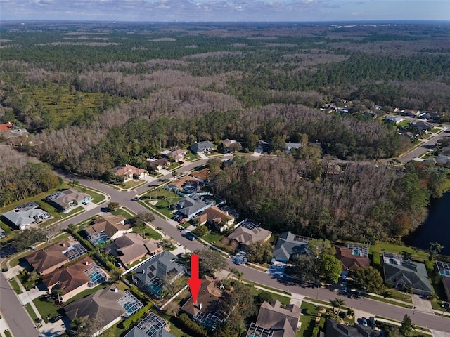 drone / aerial view with a residential view and a wooded view