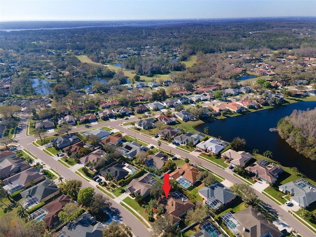 drone / aerial view with a residential view and a water view