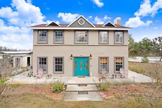 back of house with a patio