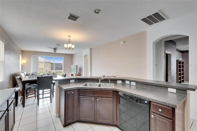 kitchen featuring sink, light tile patterned floors, black dishwasher, dark brown cabinetry, and a textured ceiling