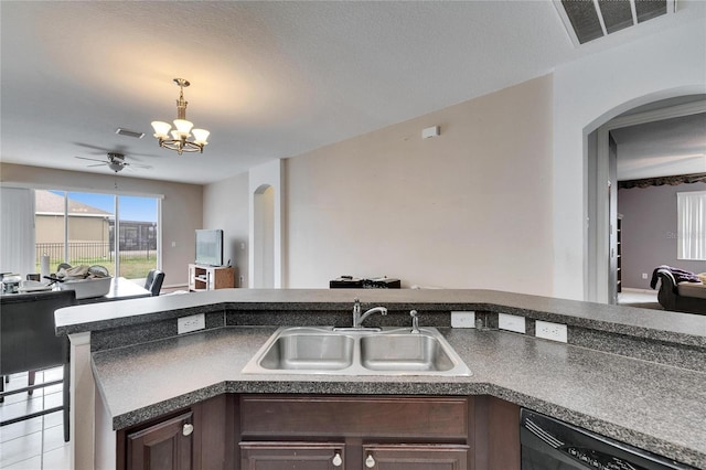 kitchen with dark brown cabinetry, sink, a notable chandelier, and dishwasher