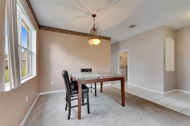 carpeted dining room featuring washer / dryer