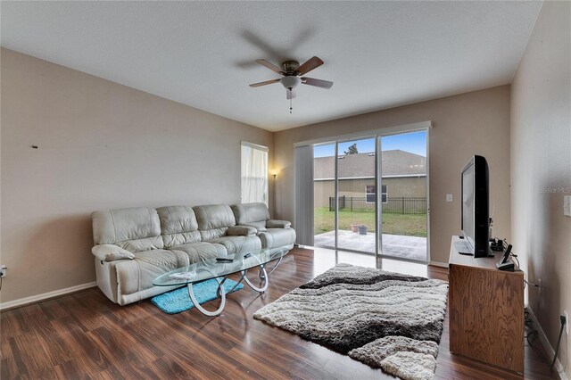 living room featuring dark hardwood / wood-style floors and ceiling fan