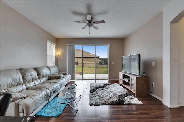 living room featuring dark hardwood / wood-style floors and ceiling fan