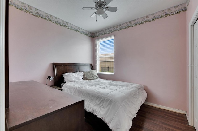 bedroom with dark wood-type flooring and ceiling fan