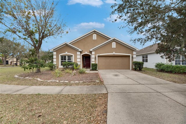 ranch-style house featuring a garage and a front yard