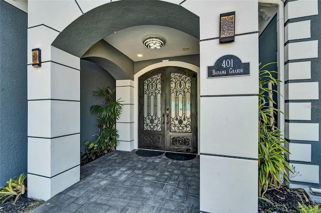 doorway to property with french doors and stucco siding