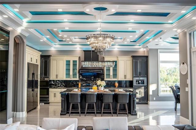 kitchen featuring a breakfast bar, dark countertops, and cream cabinetry