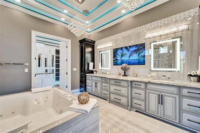 full bathroom featuring ornamental molding, a sink, a whirlpool tub, and double vanity