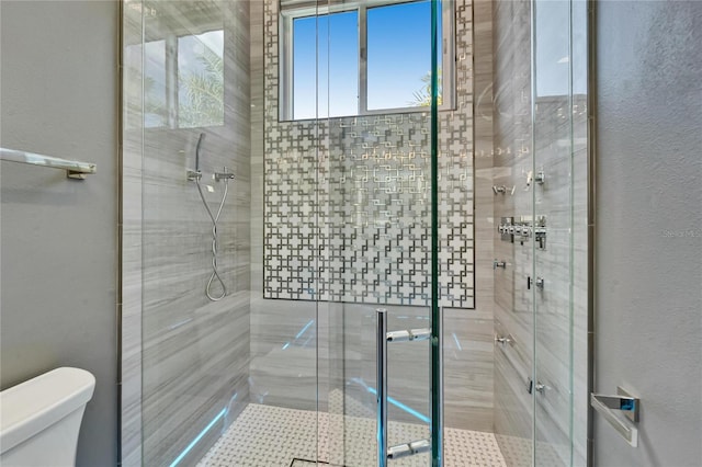 full bath with a shower stall and toilet